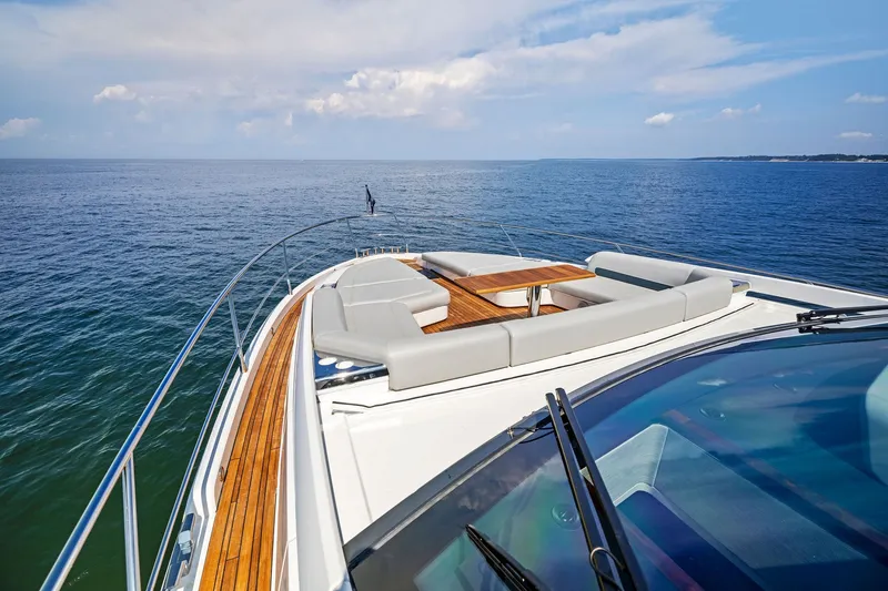 Slide: The Image of 2024 Fairline Phantom 65 yacht with luxurious deck seating, overlooking the ocean. - 67