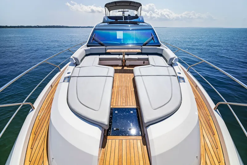 Slide: The Image of 2024 Fairline Phantom 65 yacht with luxurious deck and seating, cruising on open water. - 70