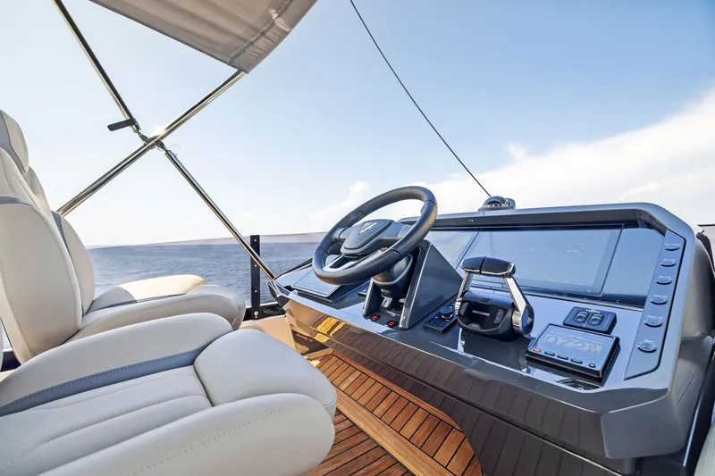 Slide: The Image of Luxurious helm of 2024 Fairline Phantom 65 yacht with modern controls and seating. - 60