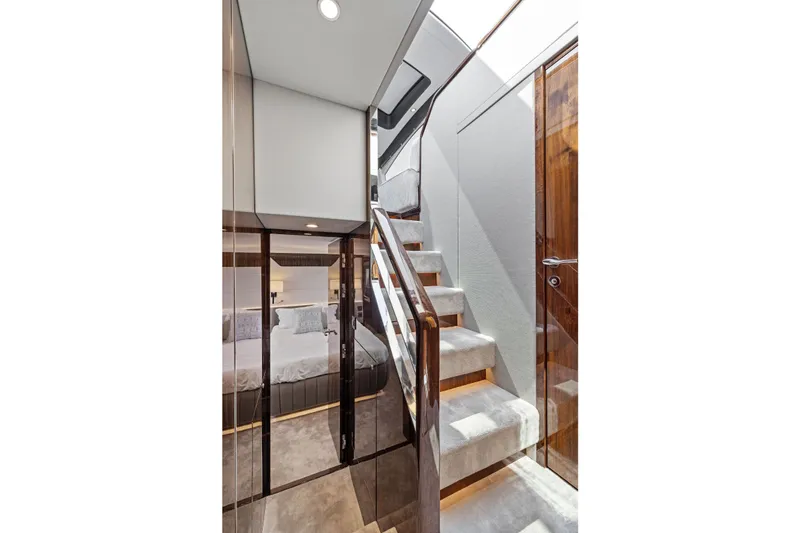 Slide: The Image of Interior of 2024 Fairline Phantom 65 yacht, featuring elegant staircase and luxurious bedroom. - 38