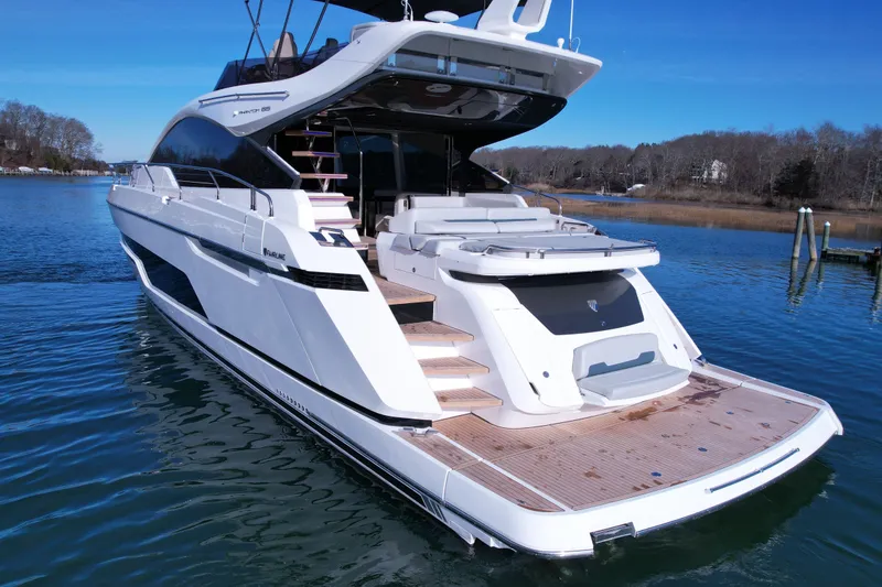 Slide: The Image of 2024 Fairline Phantom 65 yacht on serene water, showcasing sleek design and luxury features. - 3
