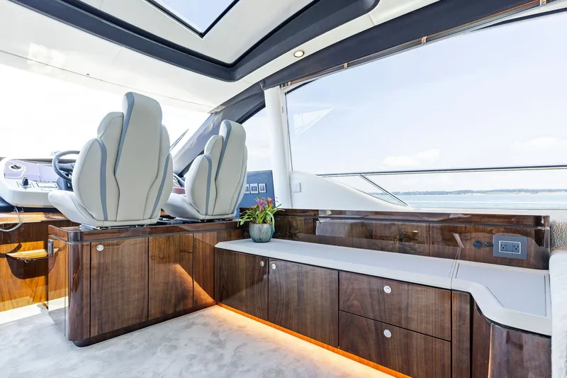 Slide: The Image of Luxurious interior of 2024 Fairline Phantom 65 yacht with elegant seating and wood finishes. - 18