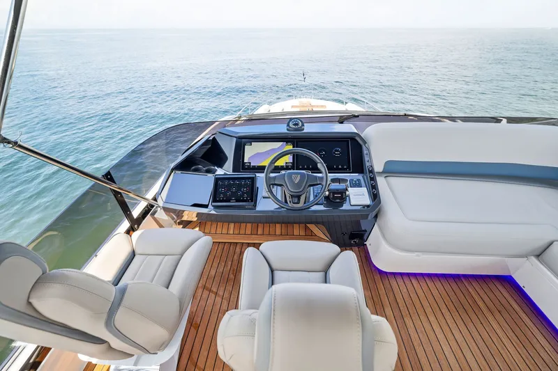 Slide: The Image of Luxurious 2024 Fairline Phantom 65 yacht cockpit with modern controls and ocean view. - 65