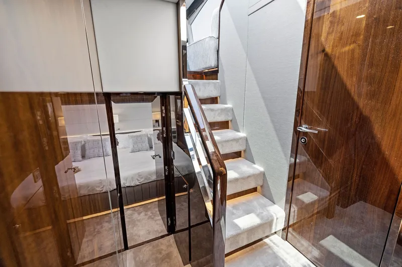 Slide: The Image of Luxurious interior of 2024 Fairline Phantom 65 yacht with elegant staircase and cozy bedroom. - 25