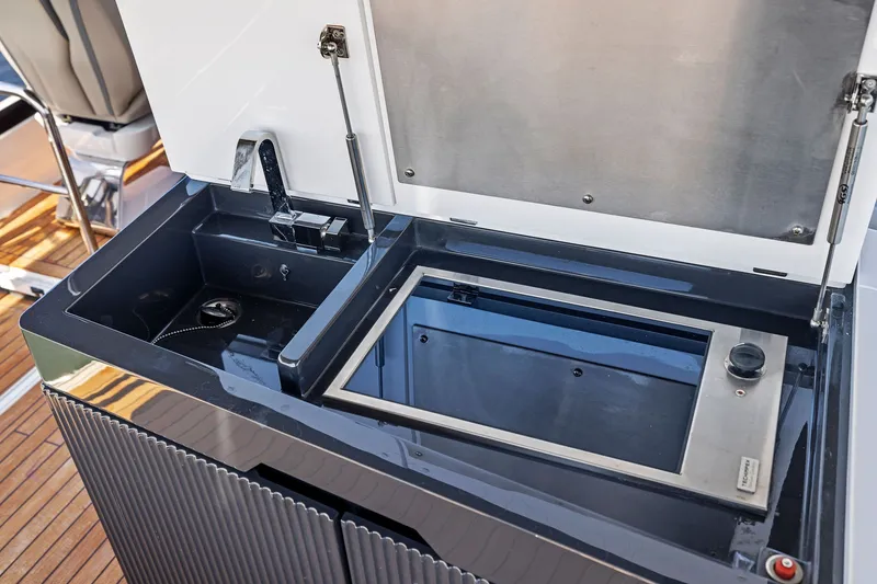 Slide: The Image of Outdoor kitchen area on 2024 Fairline Phantom 65 yacht with sink and grill. - 53