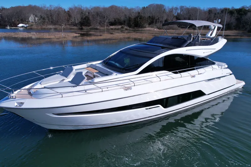 Slide: The Image of 2024 Fairline Phantom 65 luxury yacht cruising on serene waters. - 1