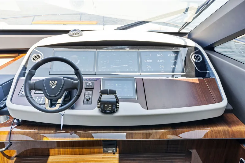 Slide: The Image of 2024 Fairline Phantom 65 yacht helm with modern controls and sleek dashboard design. - 23