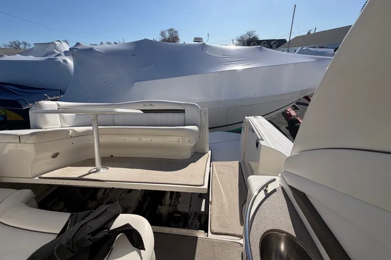 Slide: The Image of 2007 Sea Ray 40 Sundancer yacht interior with seating and table, docked outdoors. - 18