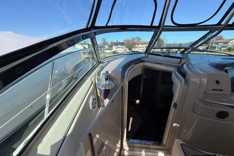 Slide: The Image of 2007 Sea Ray 40 Sundancer yacht interior with open cabin door and clear blue sky. - 10