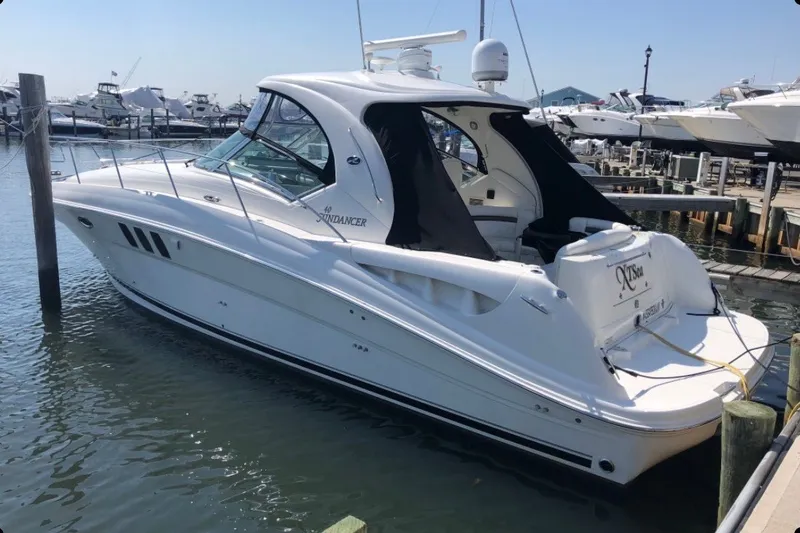 The Image of 2007 Sea Ray 40 Sundancer yacht docked at marina, featuring sleek white design. - 0