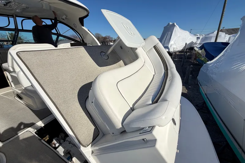 Slide: The Image of 2007 Sea Ray 40 Sundancer boat interior with white seating and carpeted flooring. - 26
