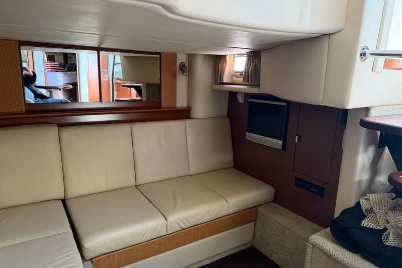 Slide: The Image of Interior of 2007 Sea Ray 40 Sundancer with beige seating and wall-mounted TV. - 7