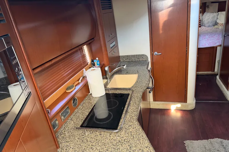 Slide: The Image of 2007 Sea Ray 40 Sundancer interior kitchen with granite countertops and modern appliances. - 14