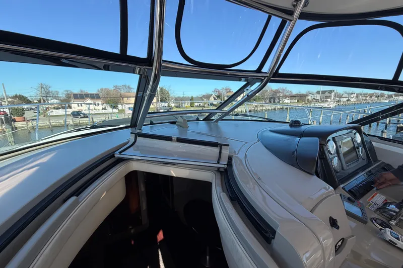 Slide: The Image of 2007 Sea Ray 40 Sundancer cockpit with marina view, showcasing helm and navigation equipment. - 19