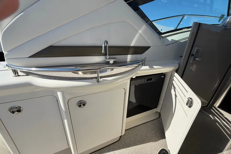 Slide: The Image of Interior view of 2007 Sea Ray 40 Sundancer yacht with open cabinet and sink. - 8