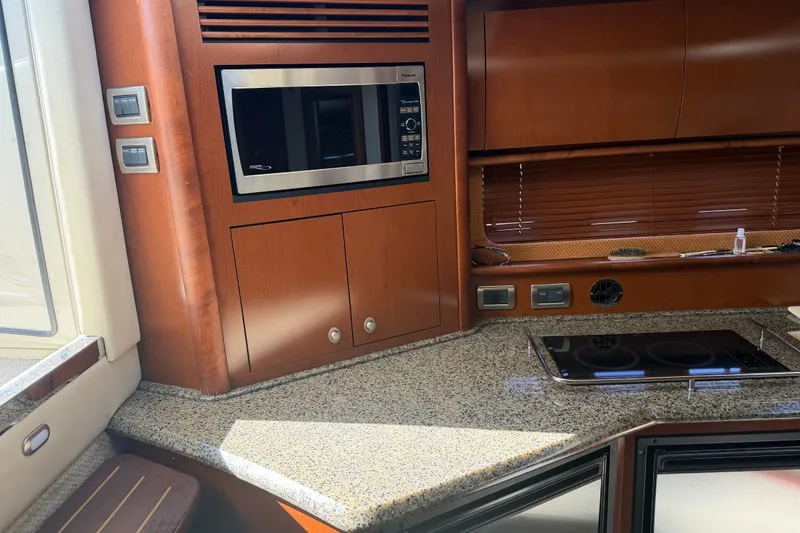Slide: The Image of 2007 Sea Ray 40 Sundancer yacht kitchen with microwave and stovetop. - 12
