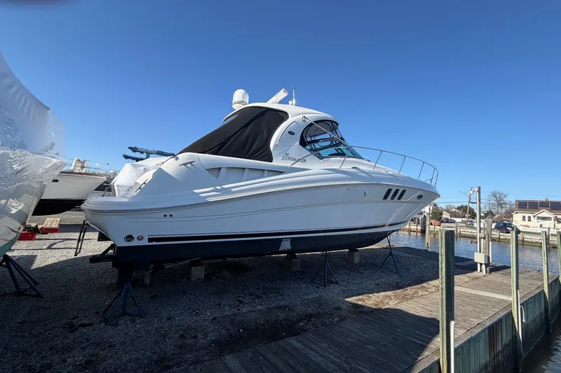 Slide: The Image of 2007 Sea Ray 40 Sundancer yacht on dry dock under clear blue sky. - 5