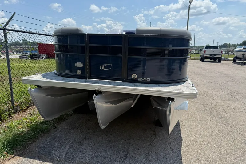 Slide: The Image of 2022 Crest 240 Classic CPTD pontoon boat parked on pavement under a cloudy sky. - 1
