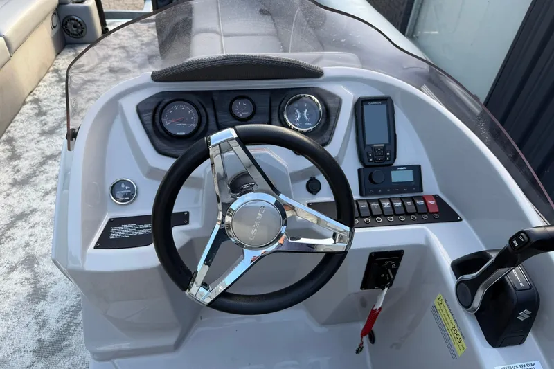 Slide: The Image of Steering console of 2022 Crest 240 Classic CPTD boat with gauges and controls. - 8