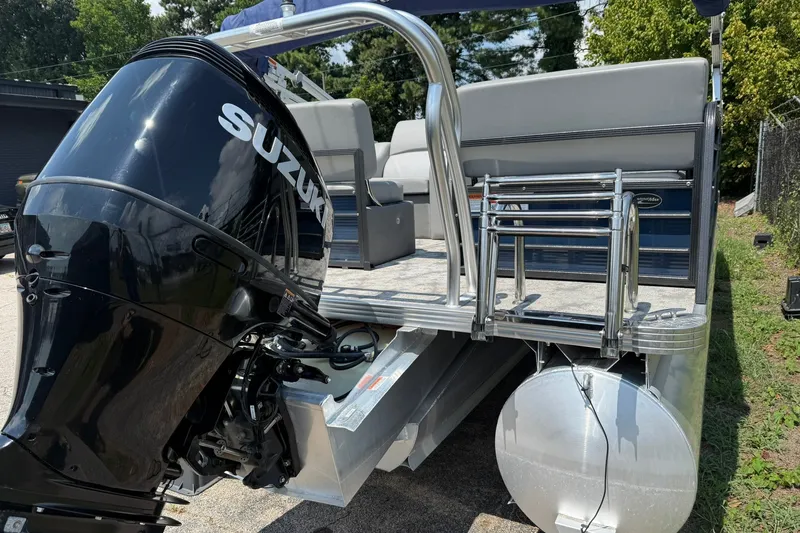Slide: The Image of 2022 Crest 240 Classic CPTD pontoon boat with Suzuki outboard motor, docked outdoors. - 5