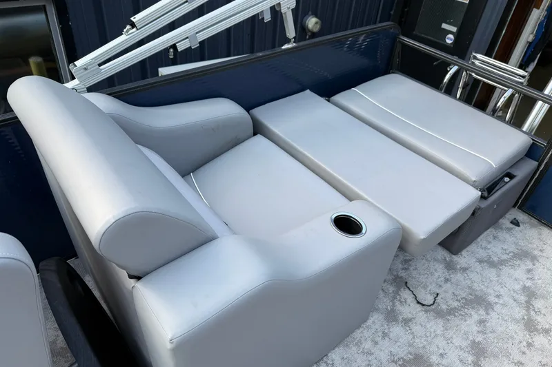 Slide: The Image of 2022 Crest 240 Classic CPTD boat interior with gray seating and cup holder. - 9