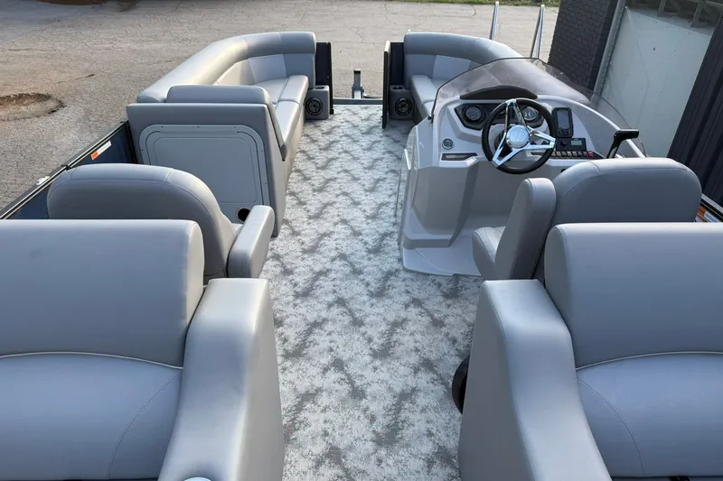 Slide: The Image of 2022 Crest 240 Classic CPTD pontoon boat interior with gray seating and modern dashboard. - 18