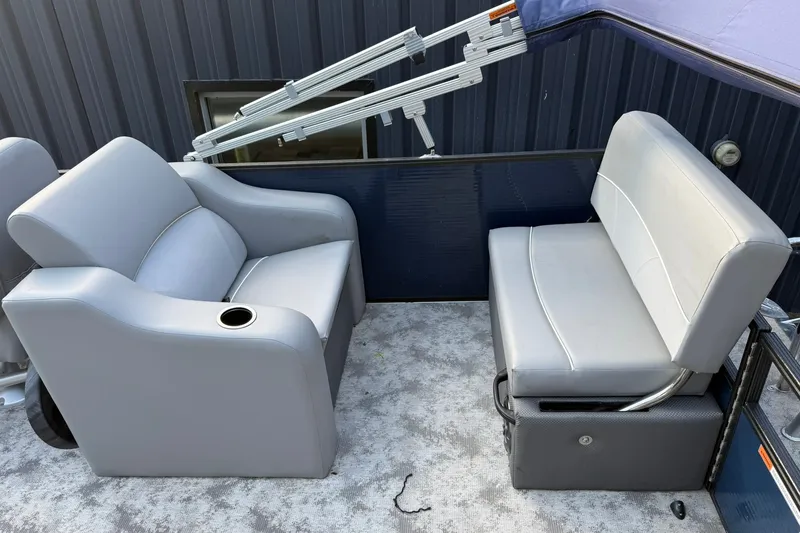 Slide: The Image of 2022 Crest 240 Classic CPTD boat interior with gray seating and cup holder. - 12