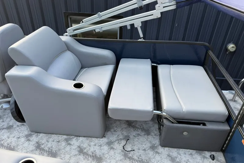 Slide: The Image of 2022 Crest 240 Classic CPTD boat seating with gray upholstery and cup holder. - 13
