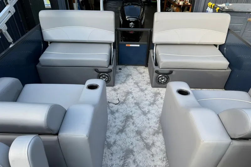 Slide: The Image of Interior of 2022 Crest 240 Classic CPTD pontoon boat with gray seating and cup holders. - 11