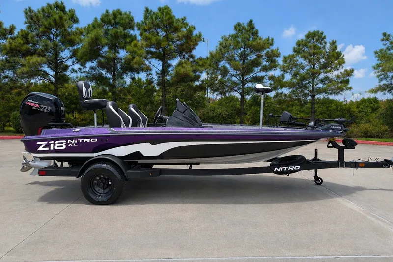 Slide: The Image of 2027 Nitro Z18 XL Pro boat on trailer, parked outdoors with trees in background. - 3