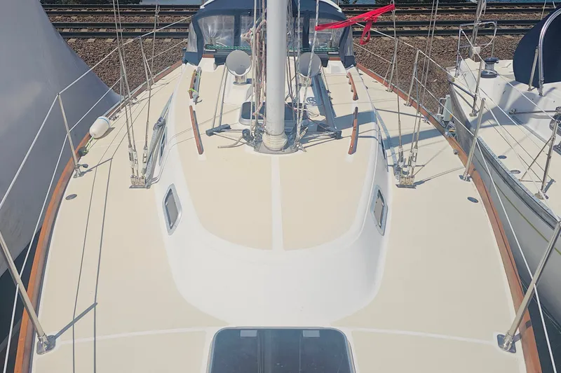 Slide: The Image of Deck view of a 1994 Tartan 3100 sailboat, showcasing clean lines and rigging. - 7