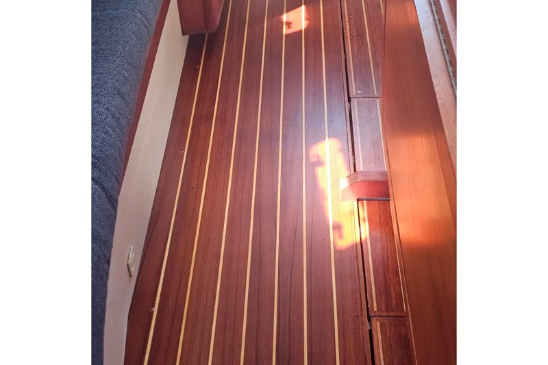 Slide: The Image of Polished wooden floor of a 1994 Tartan 3100 boat interior. - 13