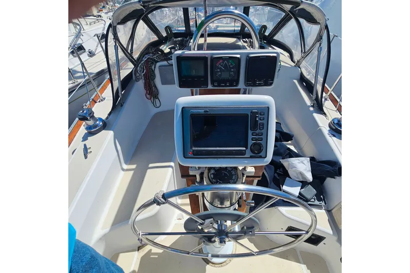 Slide: The Image of Cockpit of 1994 Tartan 3100 sailboat with navigation instruments and steering wheel. - 2