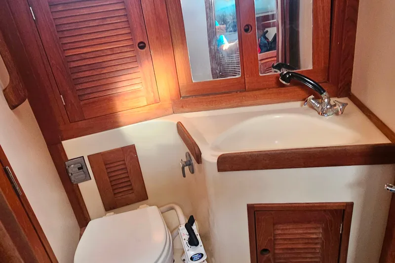 Slide: The Image of Bathroom interior of a 1994 Tartan 3100 yacht with wooden cabinetry. - 22