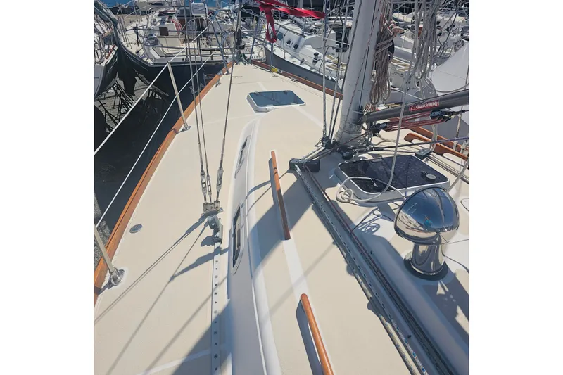 Slide: The Image of Deck view of a 1994 Tartan 3100 sailboat, showcasing rigging and fittings. - 8