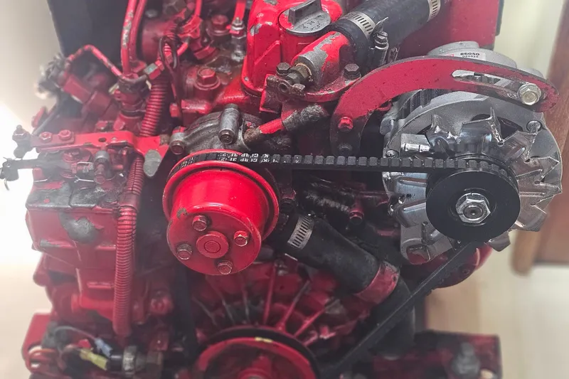Slide: The Image of Close-up of a 1994 Tartan 3100 engine with red components and visible belt system. - 23