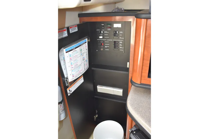 Slide: The Image of Electrical panel inside 2007 Sea Ray 270 Amberjack boat, featuring control switches and safety instructions. - 20