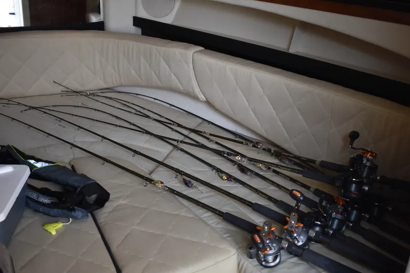 Slide: The Image of Fishing rods on a 2007 Sea Ray 270 Amberjack boat's cushioned seating area. - 18