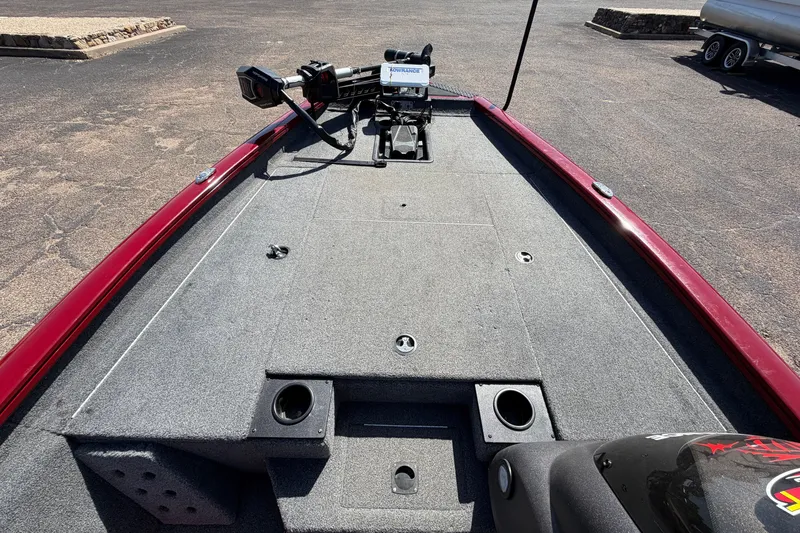 Slide: The Image of 2023 Bass Tracker Pro 17 boat deck with fishing equipment and red trim. - 16