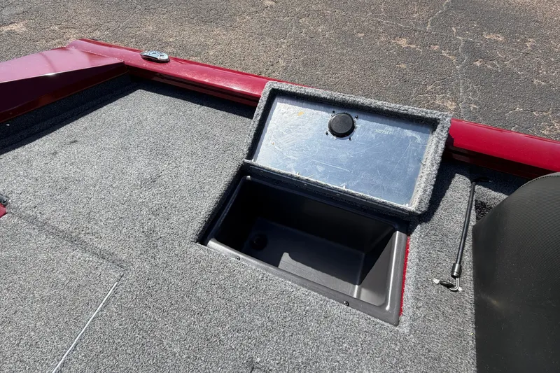 Slide: The Image of 2023 Bass Tracker Pro 17 boat storage compartment with open lid, showcasing interior space. - 31