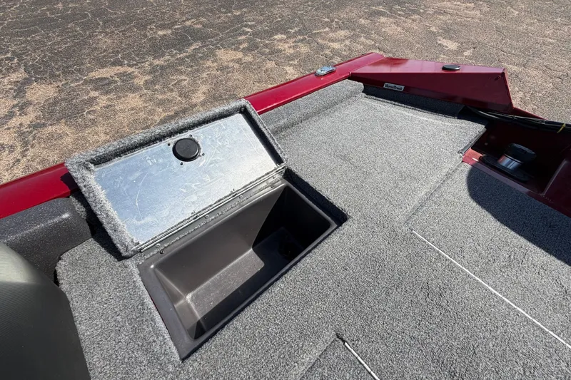 Slide: The Image of The image shows the deck of a 2023 Bass Tracker Pro 17 with an open storage compartment. - 29