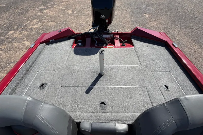 Slide: The Image of 2023 Bass Tracker Pro 17 boat interior with gray carpet and red trim. - 26
