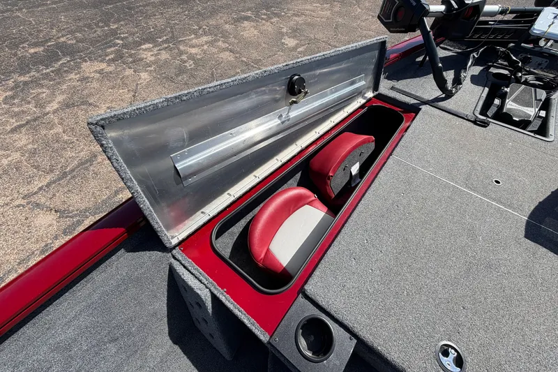 Slide: The Image of 2023 Bass Tracker Pro 17 boat storage compartment with red and gray interior. - 15