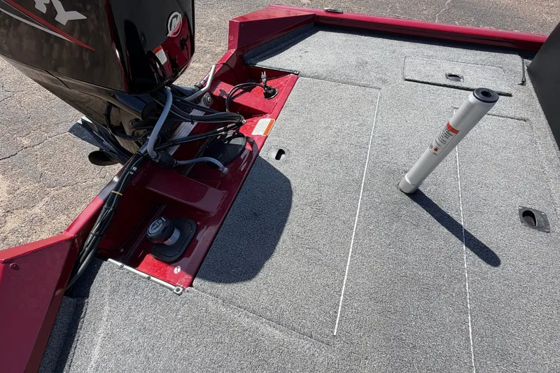 Slide: The Image of The image shows the rear of a Bass Tracker Pro 17 boat with gray carpeting and an outboard motor. - 32