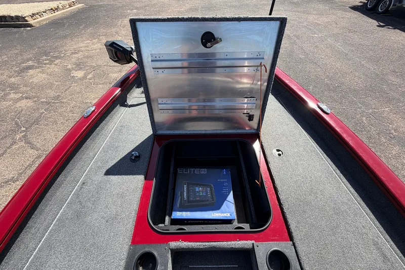 Slide: The Image of 2023 Bass Tracker Pro 17 boat with open storage compartment and Lowrance Elite 9 device. - 17