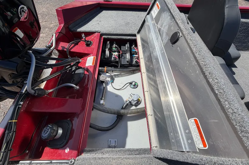 Slide: The Image of An open storage compartment at the rear of a Bass Tracker Pro 17 boat reveals batteries and wiring. - 33