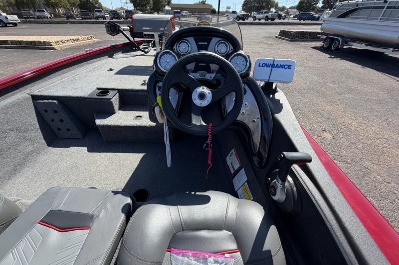 Slide: The Image of 2023 Bass Tracker Pro 17 boat interior with steering wheel and Lowrance electronics. - 25