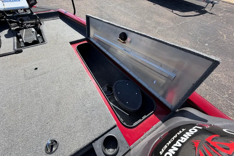 Slide: The Image of 2023 Bass Tracker Pro 17 boat interior with open storage compartment and Lowrance equipment. - 19