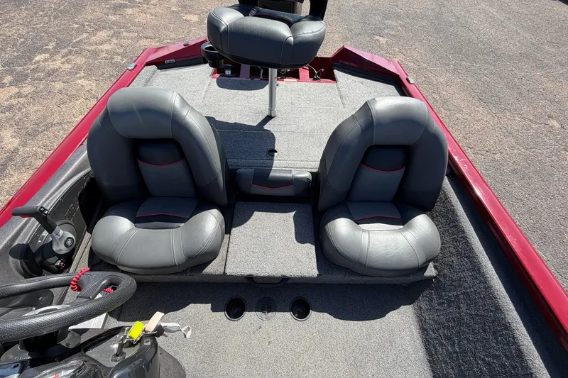 Slide: The Image of 2023 Bass Tracker Pro 17 boat interior with gray seats and red accents. - 23