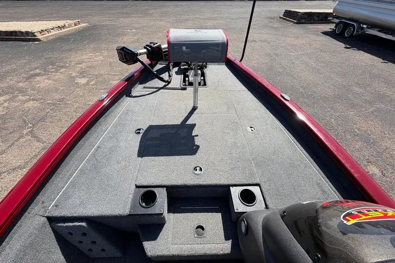 Slide: The Image of 2023 Bass Tracker Pro 17 boat deck with fishing equipment and motor. - 13